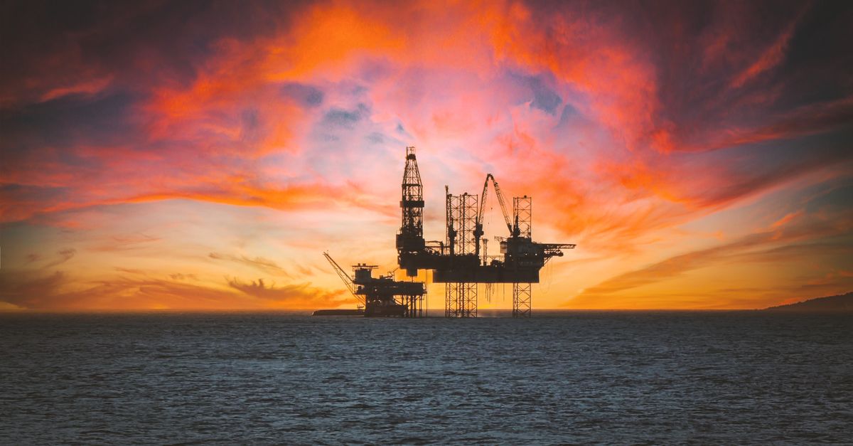 An oil platform at sunset with a stock chart overlaid, symbolising the link between geopolitics and markets
