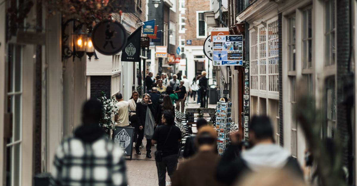 A busy shopping street in a European city with people shopping, Saturday, August 8, 2026